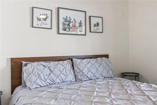 a bedroom with a bed and a chandelier fan