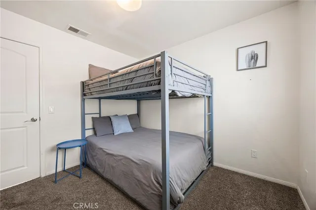 a bed with a white comforter and pillows