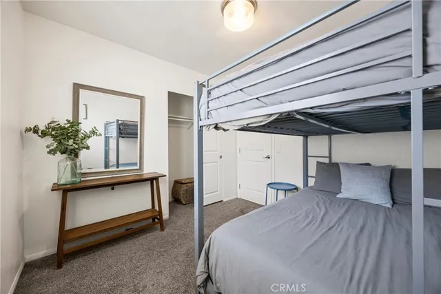 a bedroom with furniture and a wooden floor