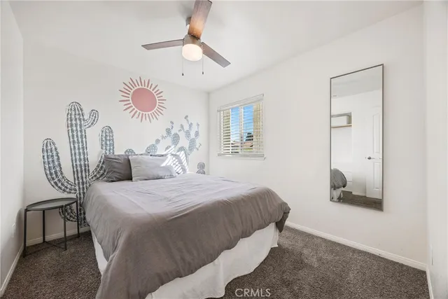 a living room with furniture and a air conditioner vent