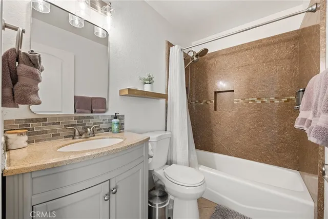a front view of a house with a yard and potted plants