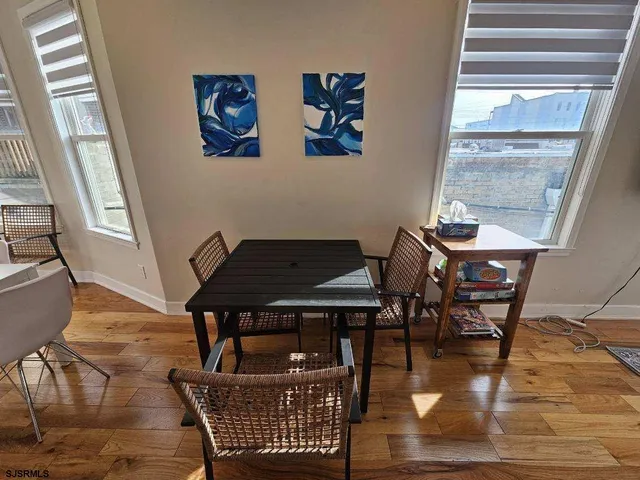 a bedroom with a bed and a flat tv screen on a dresser