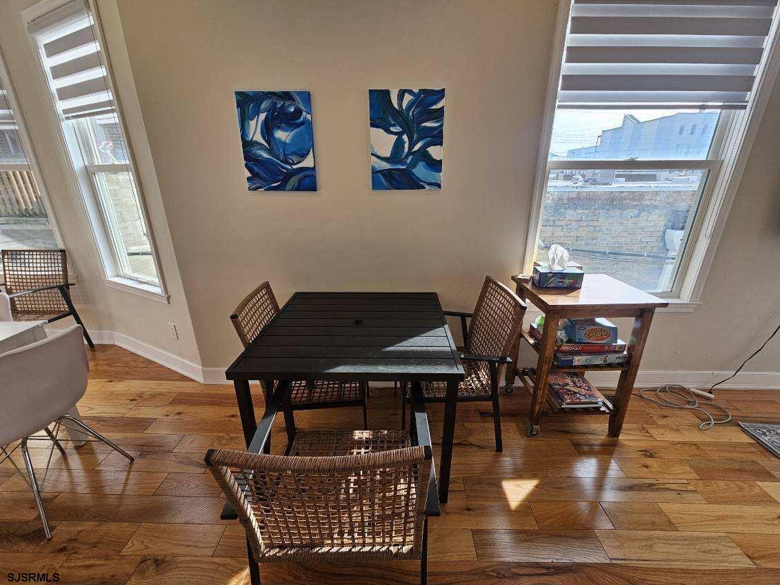 27 South Little Rock Avenue, Unit JUNE 2026 Ventnor City, NJ 08406 - Photo 22 of 91 a view of a dining room with furniture wooden floor and a window