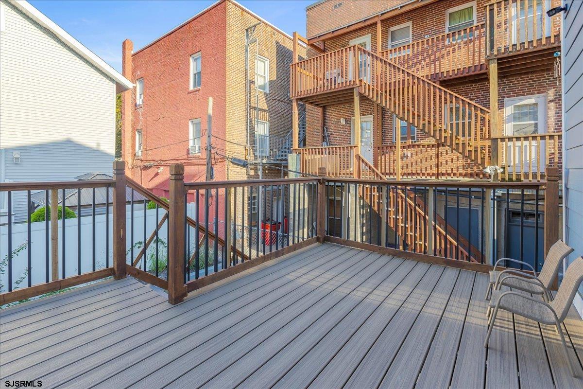 27 South Little Rock Avenue, Unit JUNE 2026 Ventnor City, NJ 08406 - Photo 28 of 91 a view of a roof deck with wooden floor and fence