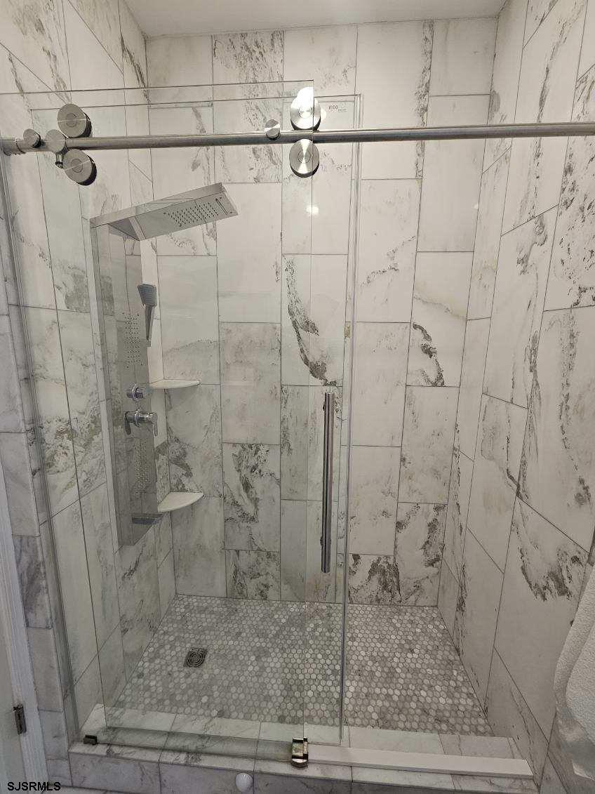 27 South Little Rock Avenue, Unit JUNE 2026 Ventnor City, NJ 08406 - Photo 31 of 91 a bathroom with a shower