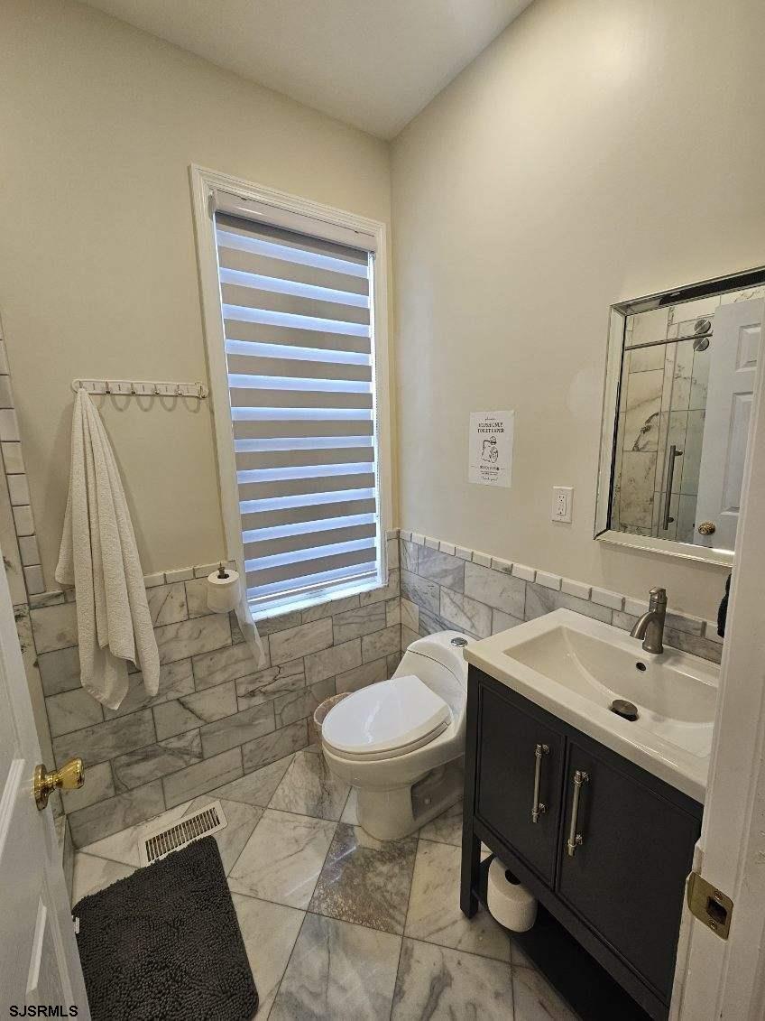 27 South Little Rock Avenue, Unit JUNE 2026 Ventnor City, NJ 08406 - Photo 32 of 91 a bathroom with a sink and a mirror