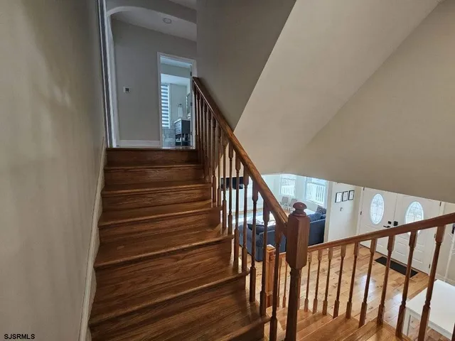 a bedroom with two beds and a chandelier