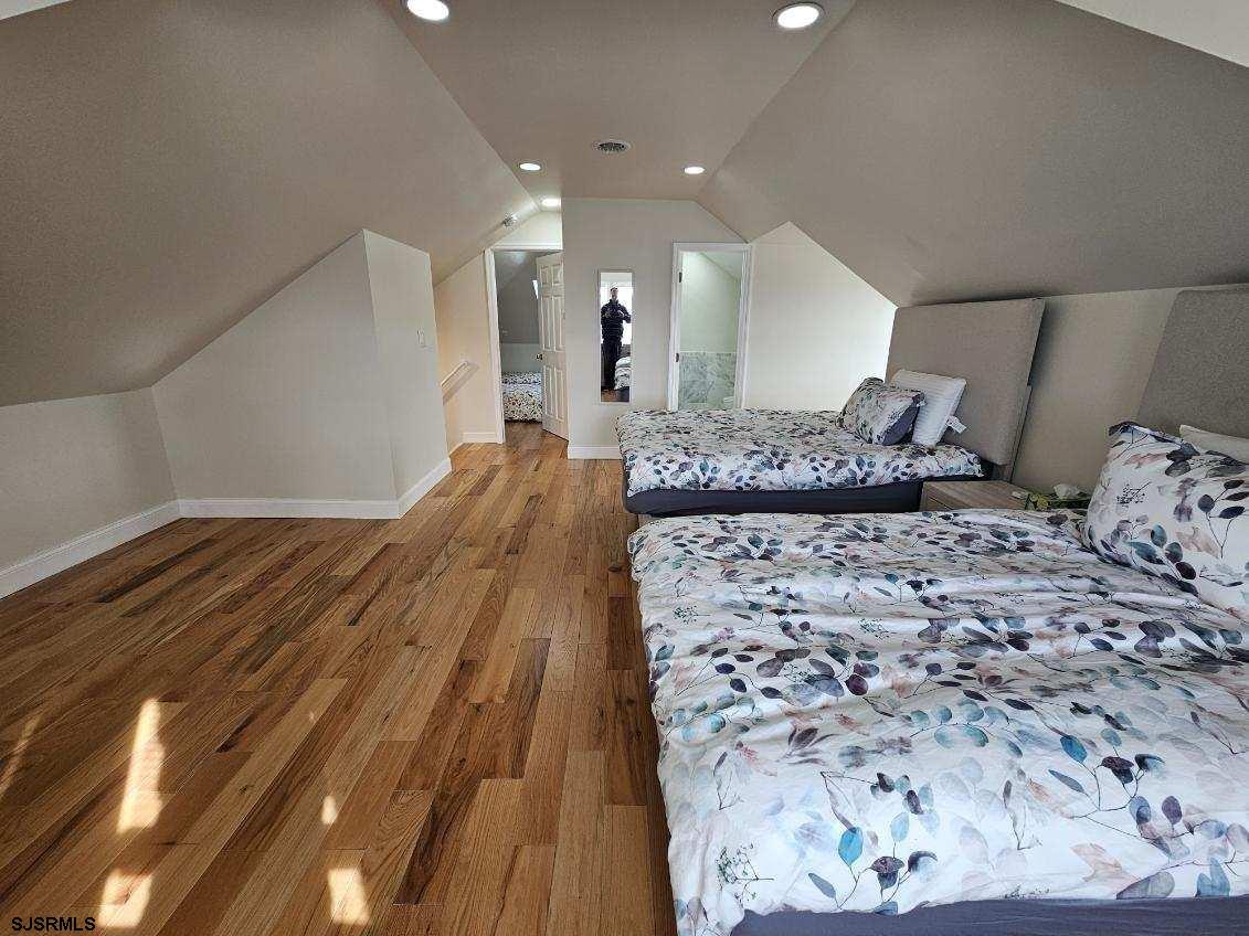 27 South Little Rock Avenue, Unit JUNE 2026 Ventnor City, NJ 08406 - Photo 41 of 91 a bedroom with a large bed and a dresser