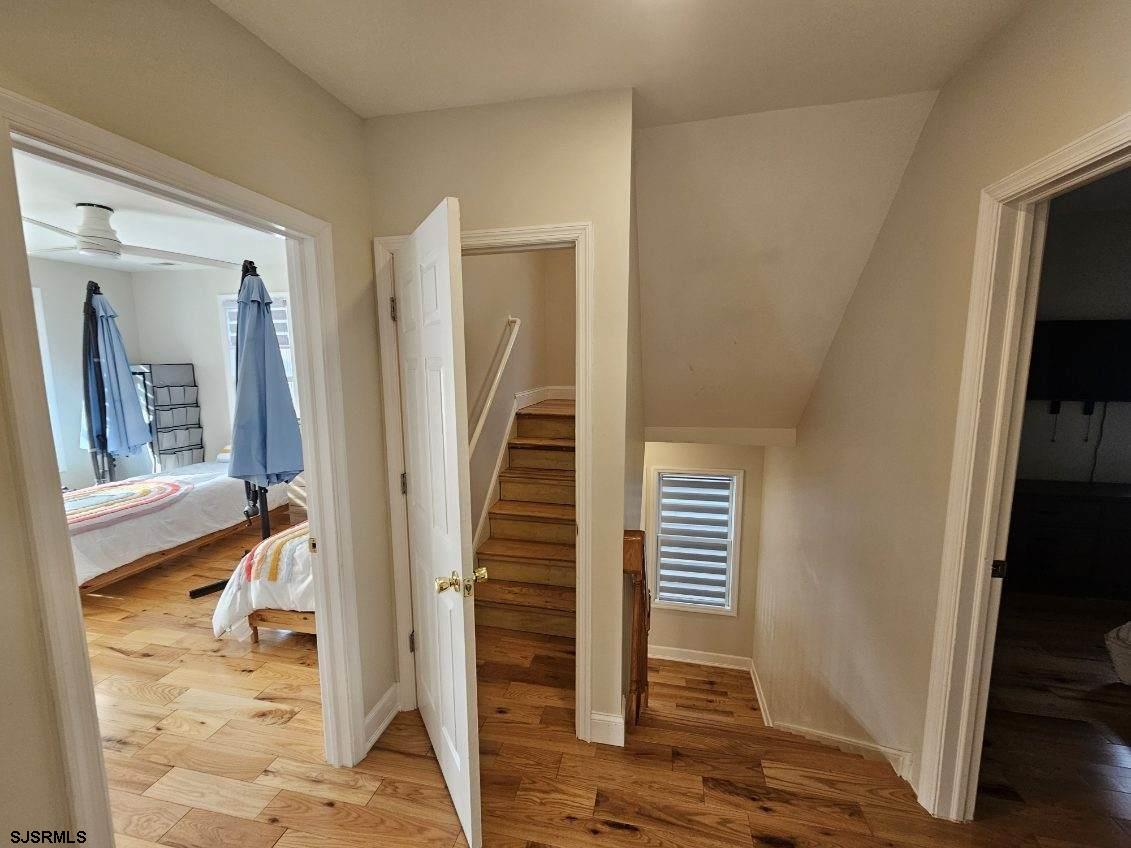 27 South Little Rock Avenue, Unit JUNE 2026 Ventnor City, NJ 08406 - Photo 49 of 91 a view of a hallway with wooden floor and staircase