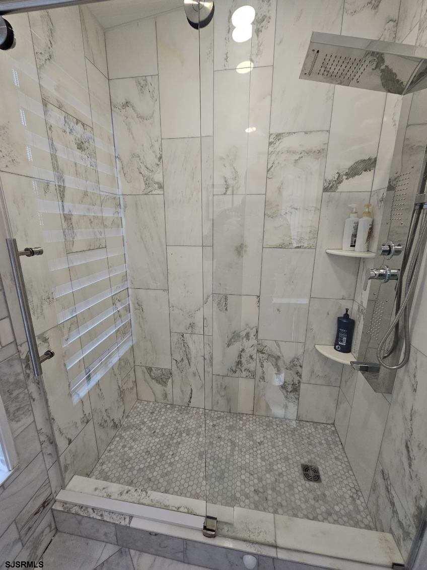 27 South Little Rock Avenue, Unit JUNE 2026 Ventnor City, NJ 08406 - Photo 52 of 91 a bathroom with a shower