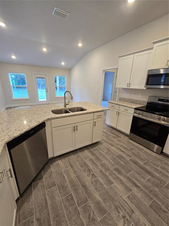 1117 Heron Point Drive Inverness, FL 34453 - Photo 11 of 19 a kitchen with stainless steel appliances granite countertop a sink stove and refrigerator