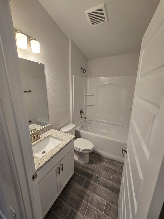 1117 Heron Point Drive Inverness, FL 34453 - Photo 14 of 19 a spacious bathroom with a granite countertop sink toilet and shower