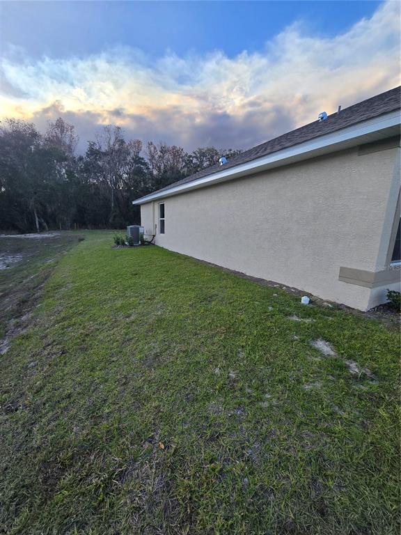 1117 Heron Point Drive Inverness, FL 34453 - Photo 3 of 19 a view of a backyard with plants and a lake view