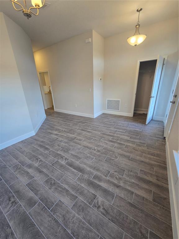 1117 Heron Point Drive Inverness, FL 34453 - Photo 5 of 19 wooden floor in an empty room with a window