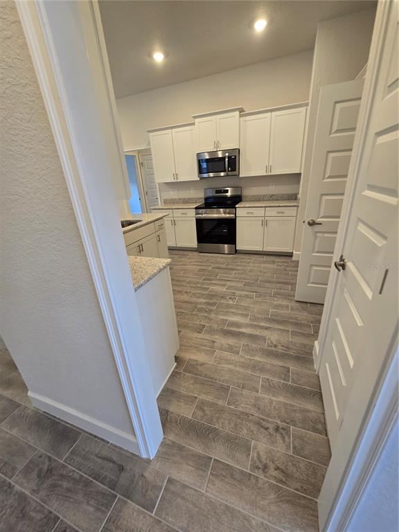1117 Heron Point Drive Inverness, FL 34453 - Photo 7 of 19 a view of a kitchen with microwave and refrigerator