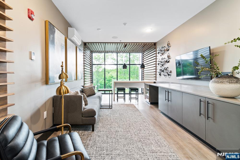 15 West Johnson Avenue, Unit 417 Bergenfield, NJ 07621 - Photo 5 of 12 a living room with furniture large window and flat screen tv