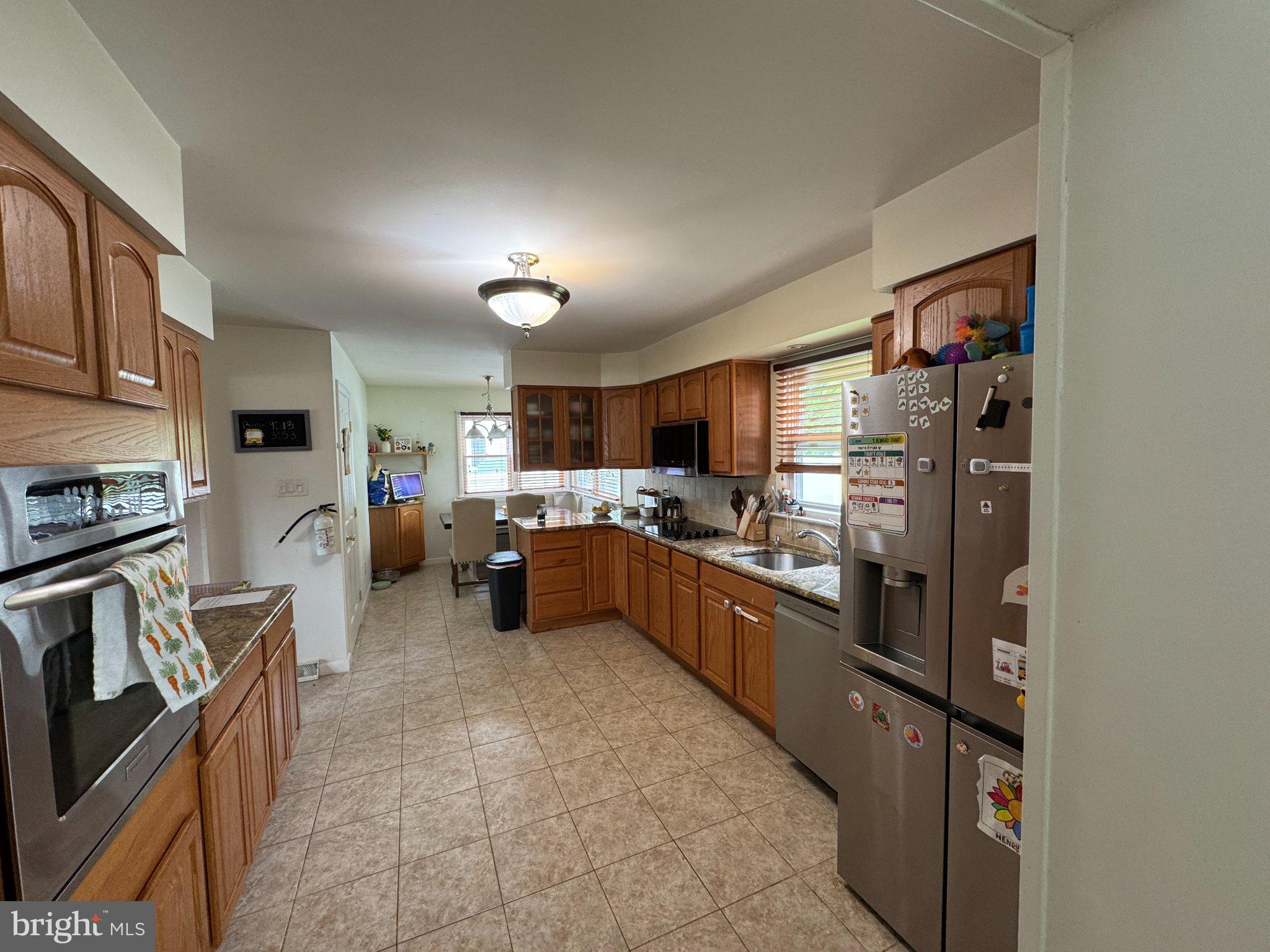321 Surrey Road Cherry Hill, NJ 08002 - Photo 7 of 24 a kitchen with refrigerator and cabinets