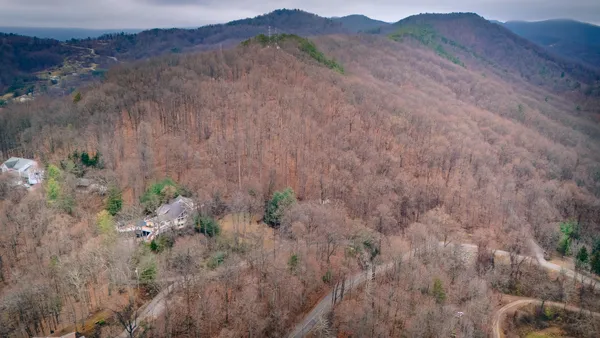 a view of a lush green hillside and a building