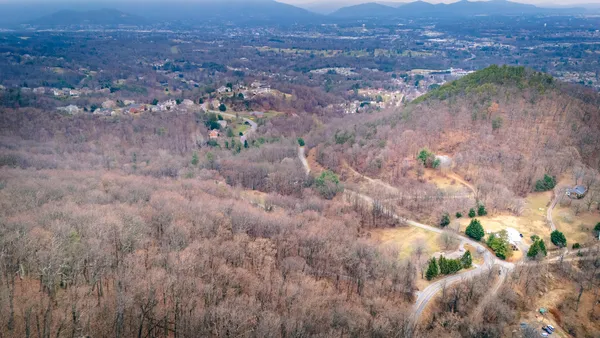 a view of a dry field with trees