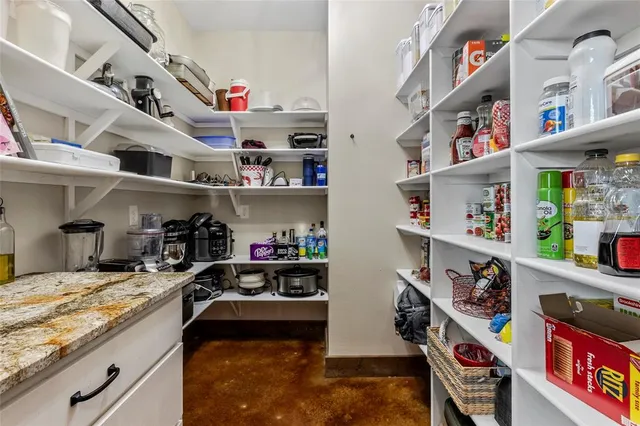 a kitchen with lots of clutter and stainless steel appliances