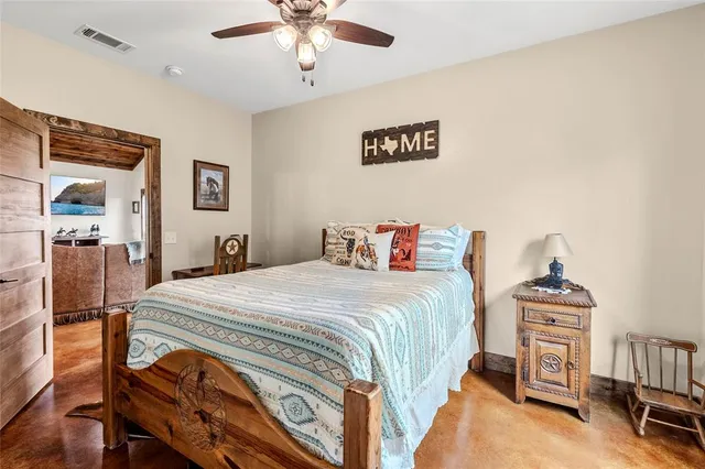 a bedroom with a bed and a chandelier