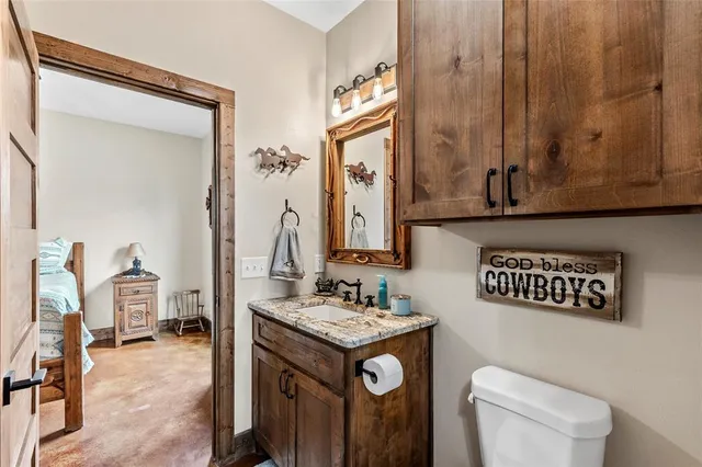 a bathroom with a sink a toilet and mirror