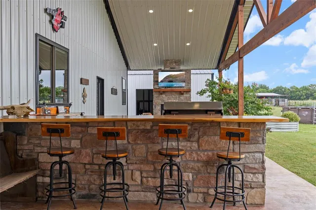 a kitchen with a table chairs and a floor to ceiling window