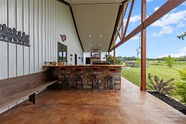 a view of a patio with a table and chairs