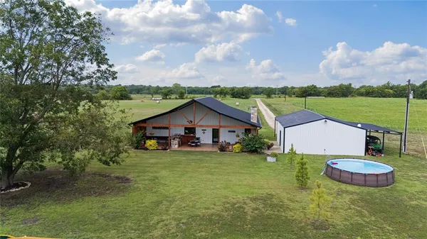 a view of a house with yard and a garden