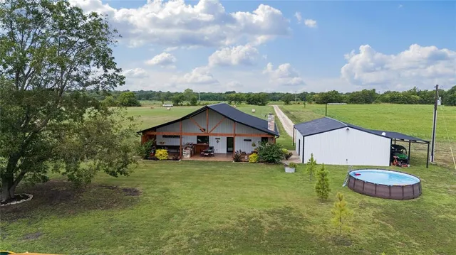 a view of a house with yard and a garden