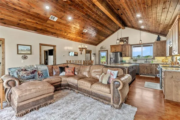 a living room with furniture and a chandelier