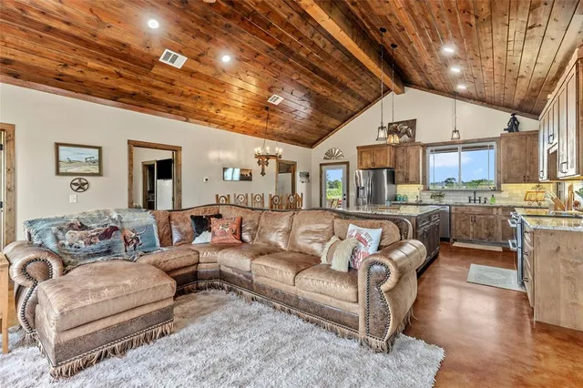 a living room with furniture and a chandelier