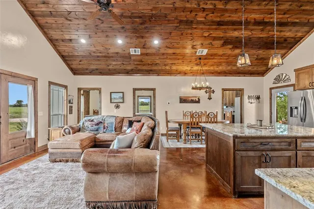 a living room with fireplace furniture and a chandelier