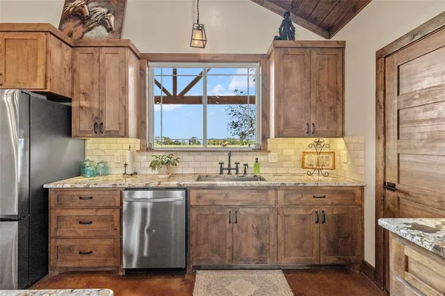 a kitchen with stainless steel appliances a sink stove and refrigerator