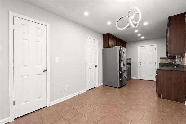 a view of a kitchen with refrigerator and workspace