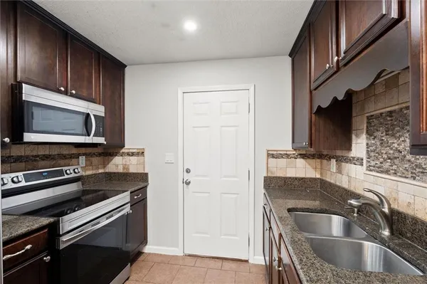 a kitchen with a sink and a microwave
