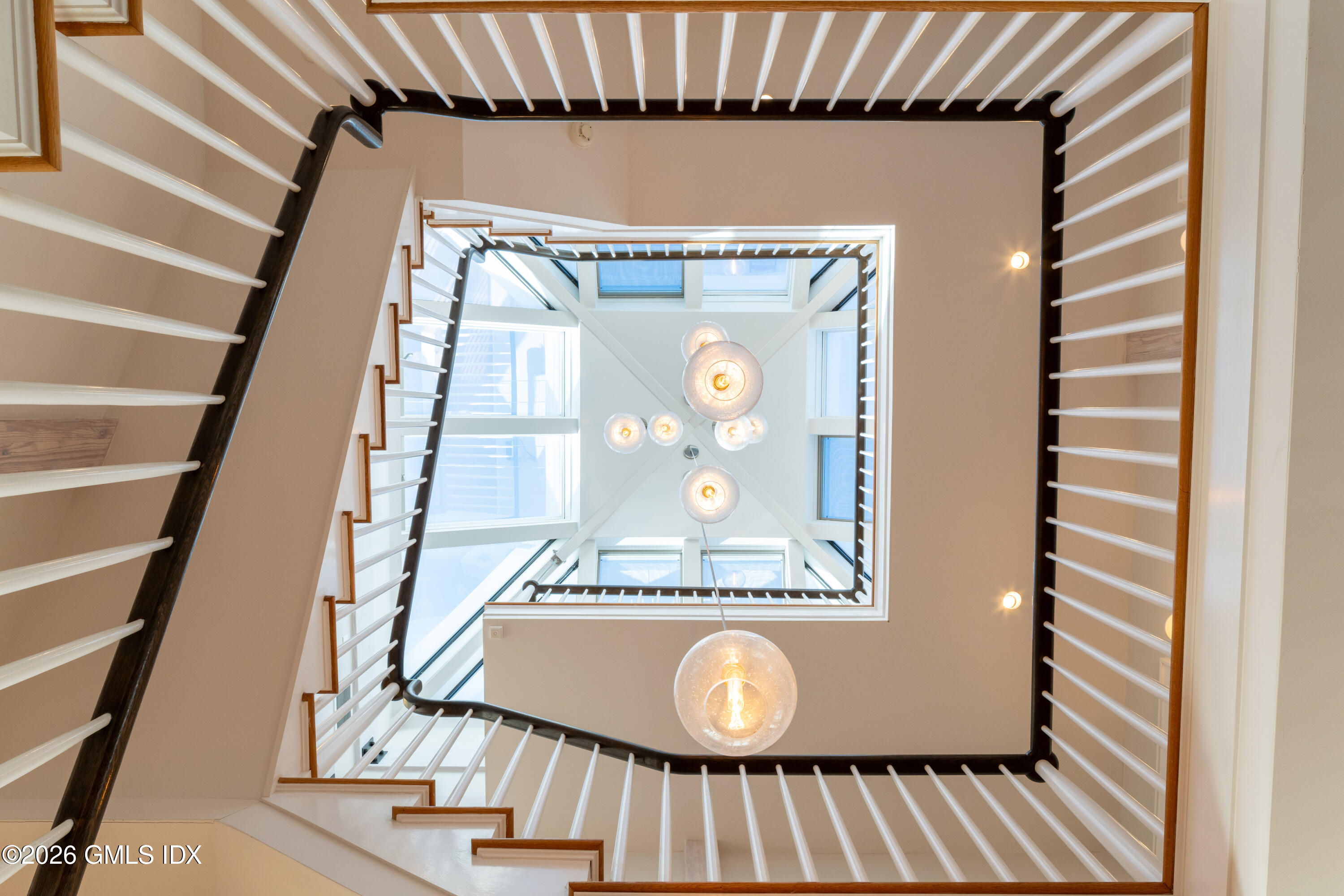 189 Shore Road Old Greenwich, CT 06870 - Photo 17 of 38 a view of a hallway with wooden floor and staircase
