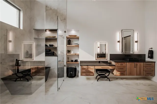 a large kitchen with cabinets a sink and stainless steel appliances