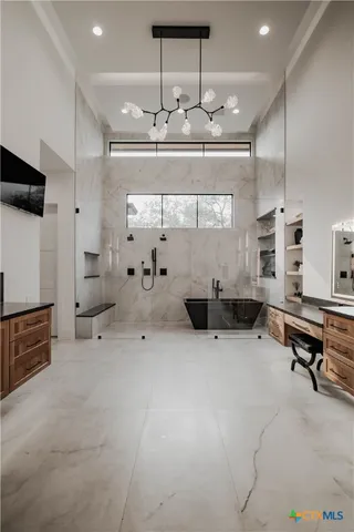 a kitchen with a refrigerator and white cabinets