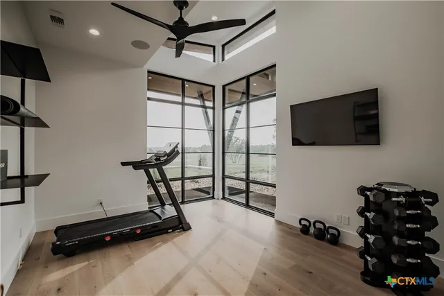 a bedroom with a bed and a flat tv screen on the dresser