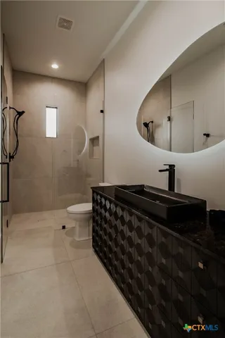 a bedroom with a bed and a book shelf