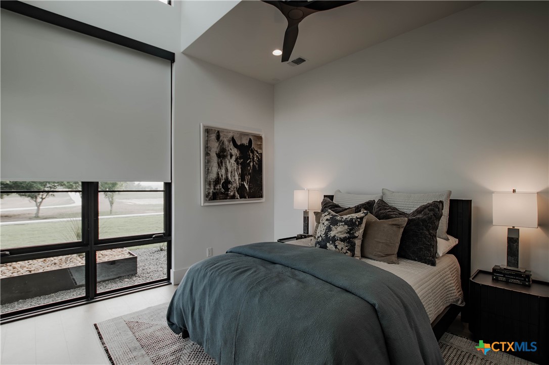 3466 Levi Sloan Road Victoria, TX 77904 - Photo 28 of 48 a bedroom with a bed and a painting on the wall