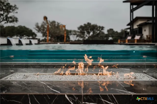 a view of a patio with swimming pool table and chairs