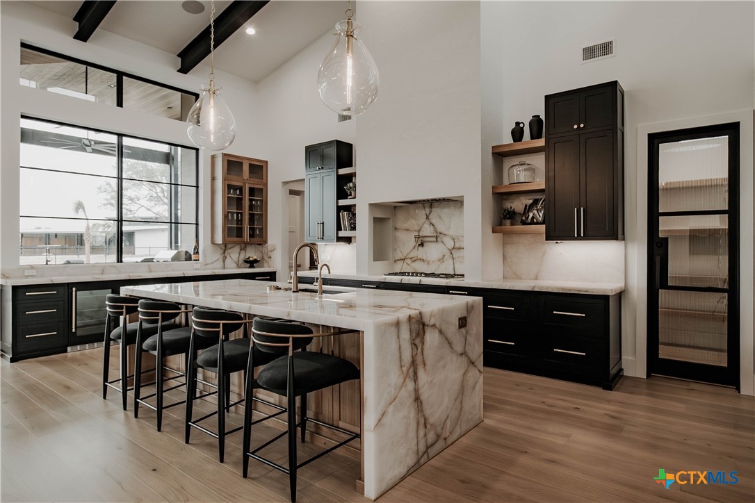 3466 Levi Sloan Road Victoria, TX 77904 - Photo 9 of 48 a kitchen with stainless steel appliances granite countertop a stove a sink dishwasher and a refrigerator with wooden floor