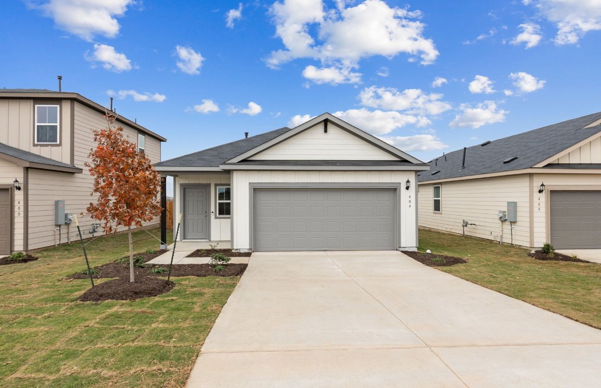 404 Sullivan Way Elgin, TX 78621 - Photo 3 of 23 a front view of a house with garden