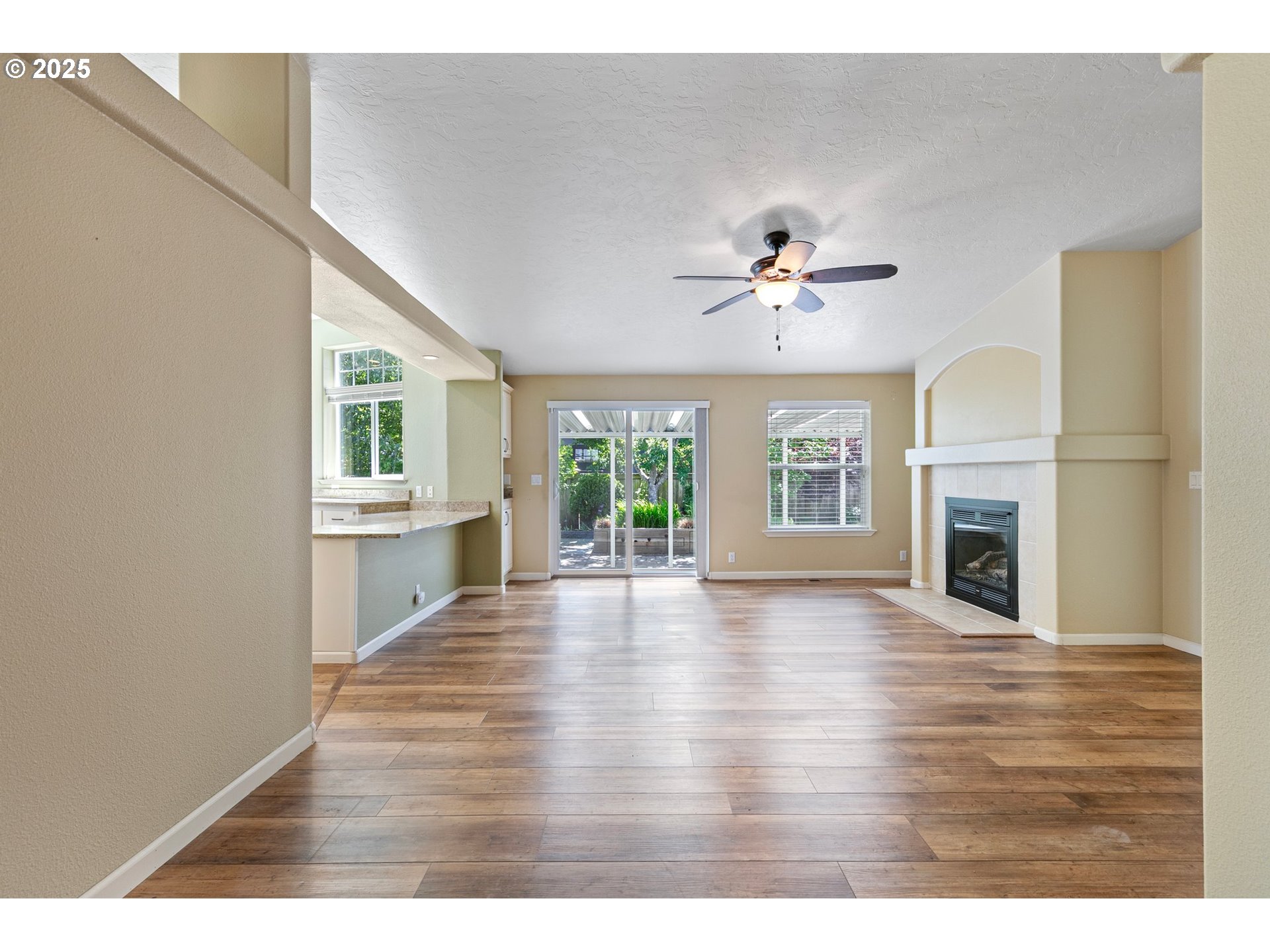 3220 Crescent Avenue, Unit 59 Eugene, OR 97408 - Photo 12 of 43 a view of an empty room with a fireplace and wooden floor