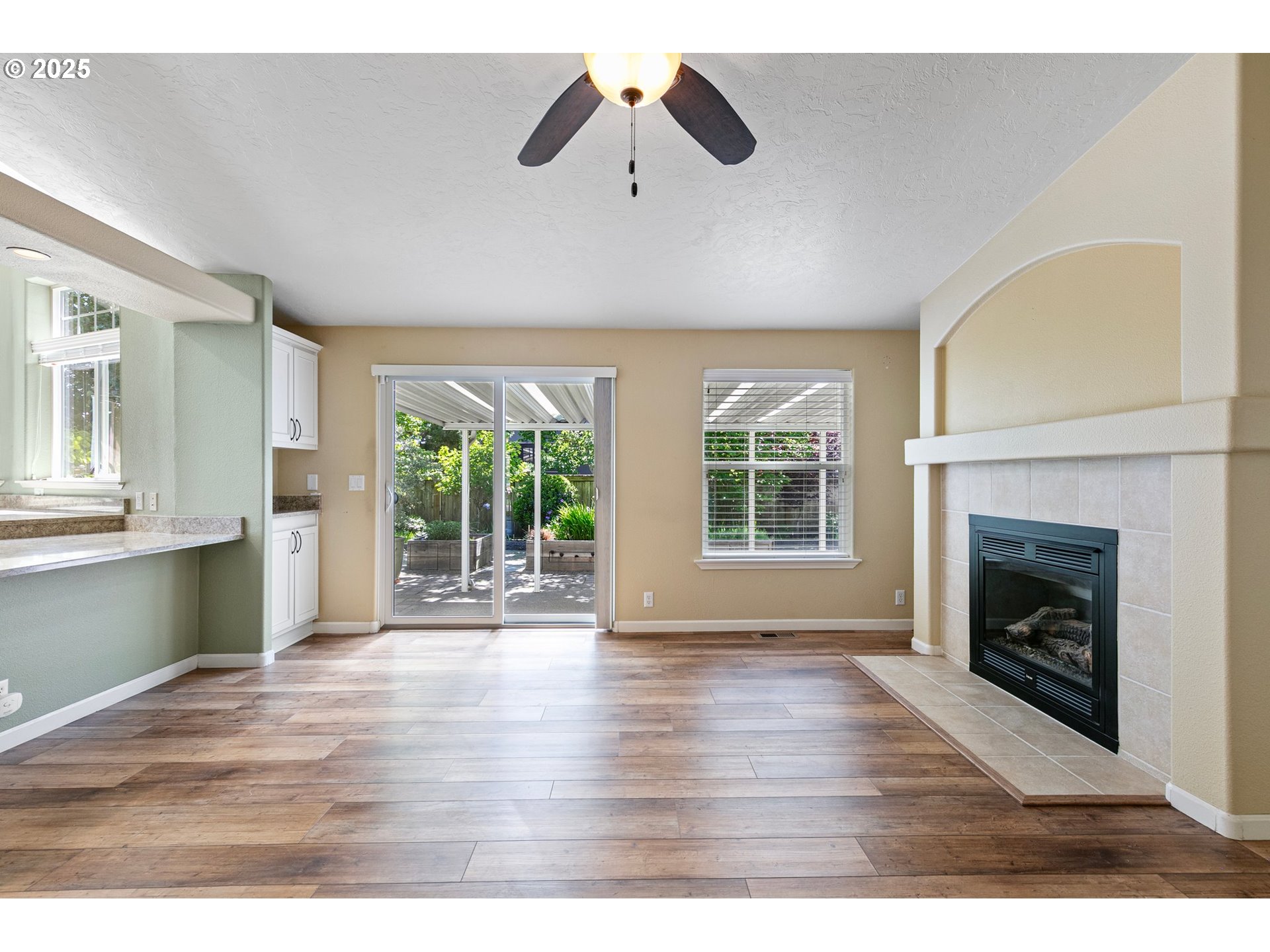 3220 Crescent Avenue, Unit 59 Eugene, OR 97408 - Photo 14 of 43 a view of an empty room with wooden floor fireplace and a window