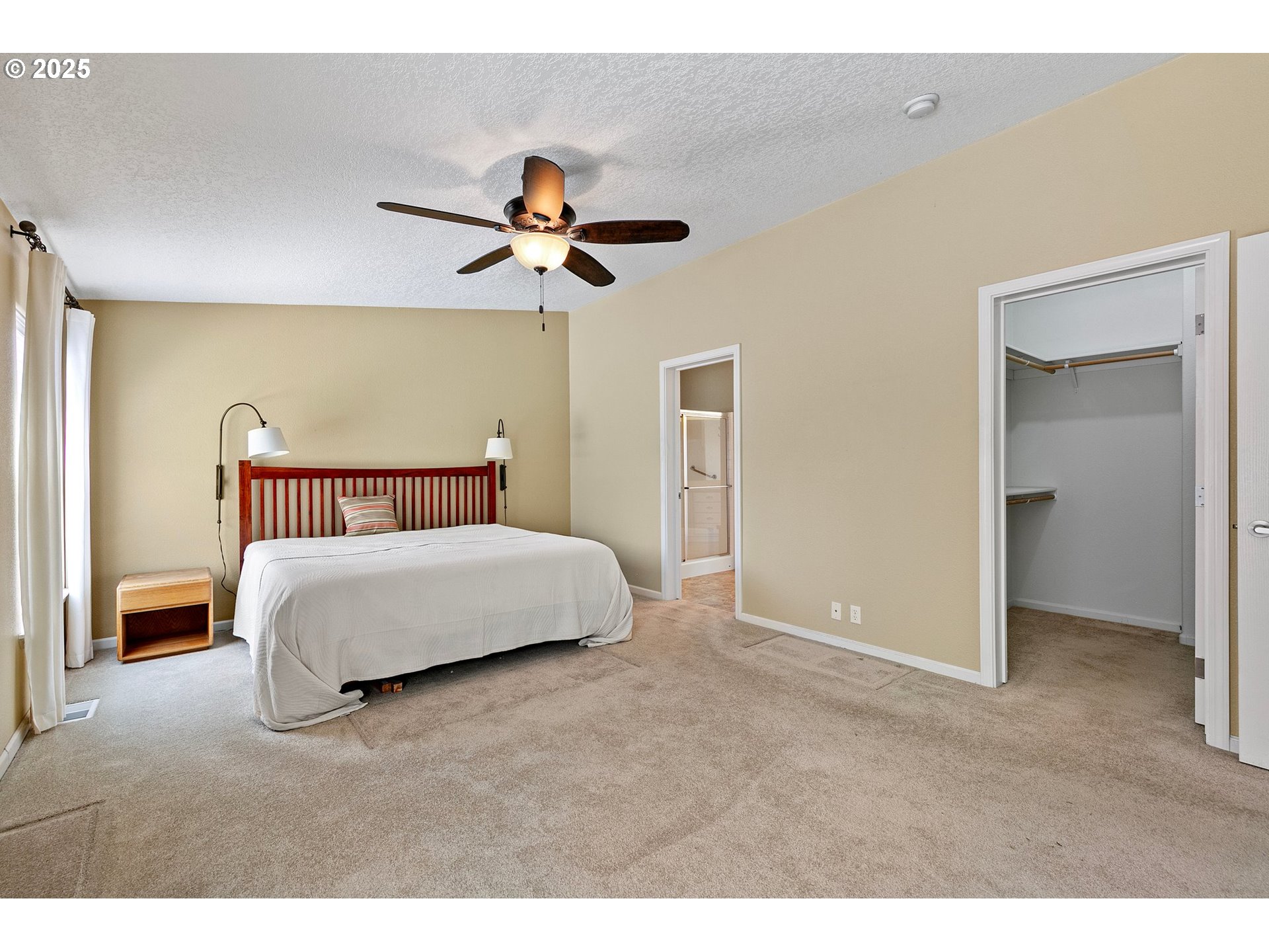 3220 Crescent Avenue, Unit 59 Eugene, OR 97408 - Photo 30 of 43 a bedroom with a large bed and a chandelier