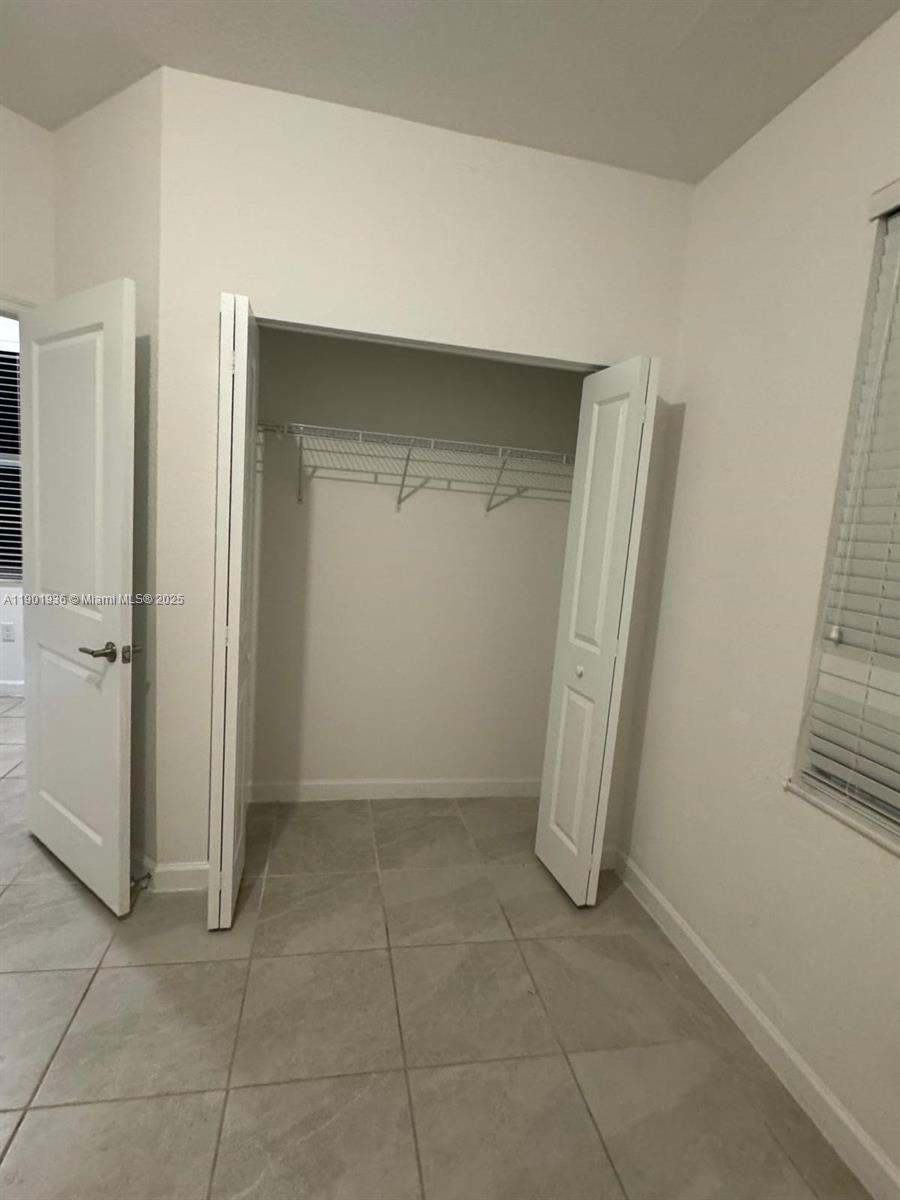 1663 Southeast 26th Street Homestead, FL 33035 - Photo 11 of 22 an empty room with windows