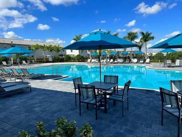a view of a swimming pool with outdoor seating